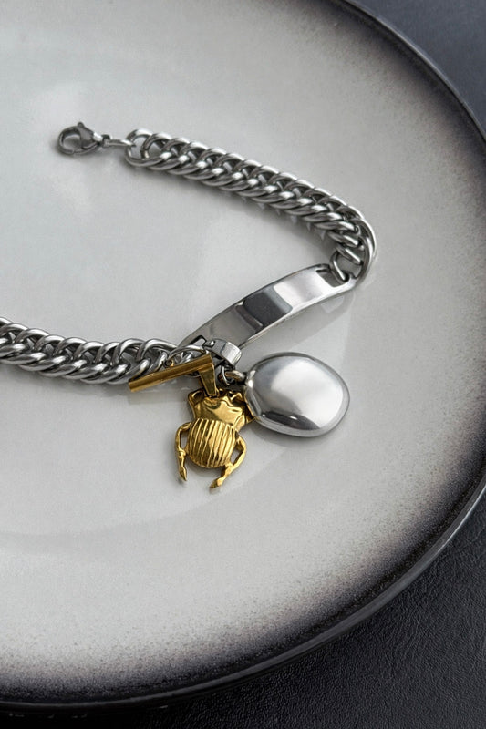 Γυναικείο statement βραχιόλι από ατσάλι σε ασημί χρώμα με χοντρή αλυσίδα και δίχρωμα στοιχεία 