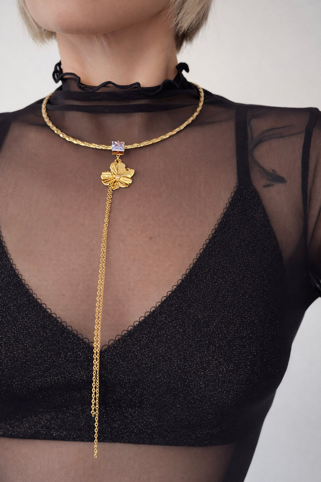 Γυναικεία λαιμαριά από ατσάλι σε χρυσό με λουλούδι και τετράγωνο ζιργκόν on body