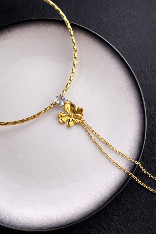 Γυναικεία λαιμαριά από ατσάλι σε χρυσό με λουλούδι και τετράγωνο ζιργκόν